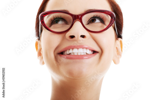 Photo: Portrait of young beautiful woman looking up and smiling. Portrait of young beautiful woman looking up and smiling.