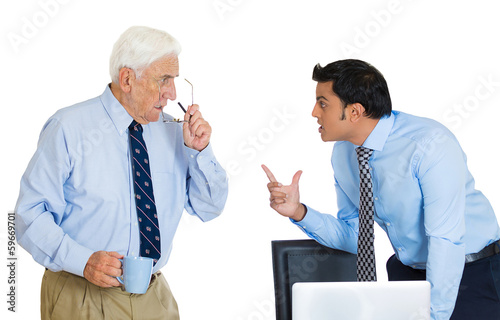 Photo: Conflict at work. Two business men fighting in office Conflict at work. Two business men fighting in office