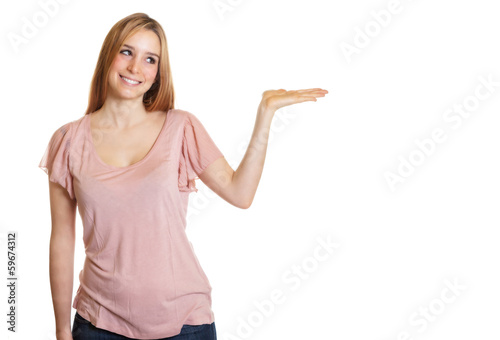 Photo: Woman with long blond hair presents something Woman with long blond hair presents something