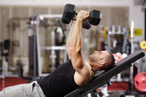 Photo: Athletic man working his chest Athletic man working his chest