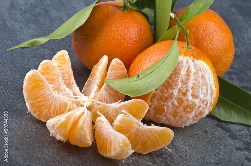 Photo: Orange mandarin or tangerine fruit with leaves Orange mandarin or tangerine fruit with leaves