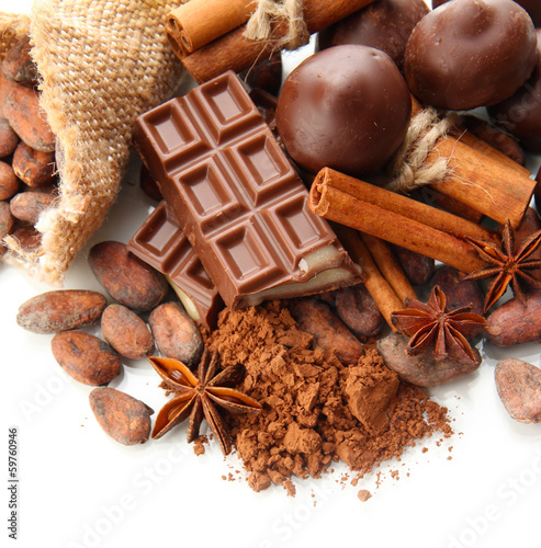 Photo: Composition of chocolate sweets, cocoa and spices, isolated Composition of chocolate sweets, cocoa and spices, isolated