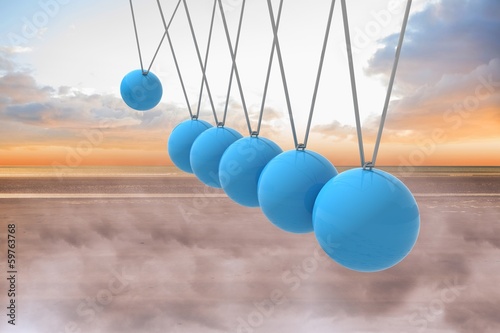 Photo: Newtons cradle above beach Newtons cradle above beach