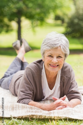 Photo: Portrait of a smiling senior woman at park Portrait of a smiling senior woman at park