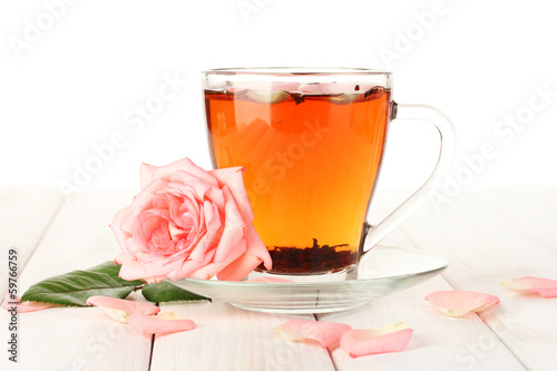 Photo: cup of tea with roses on white wooden table cup of tea with roses on white wooden table