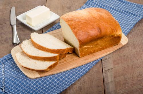 Photo: Loaf of sliced bread with butter plate Loaf of sliced bread with butter plate