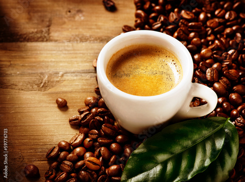 Photo: Coffee Espresso. Cup Of Coffee with Beans and Green Leaf Coffee Espresso. Cup Of Coffee with Beans and Green Leaf