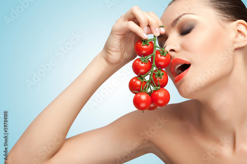 Photo: Woman with tomatoes. Woman with tomatoes.