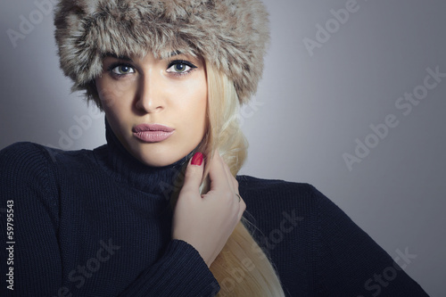 Photo: Beautiful Fashion Blond Woman in Fur Hat. Winter Girl Beautiful Fashion Blond Woman in Fur Hat. Winter Girl