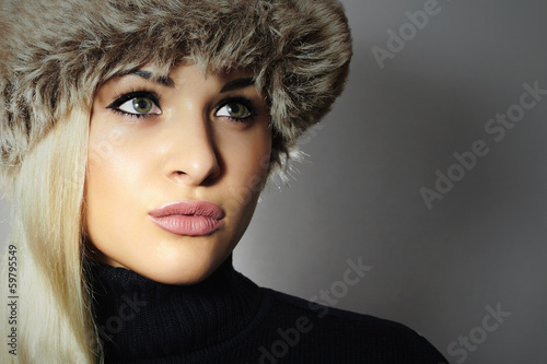 Photo: Beautiful Blond Young Woman in Fur Hat. Beauty Girl. Winter Beautiful Blond Young Woman in Fur Hat. Beauty Girl. Winter