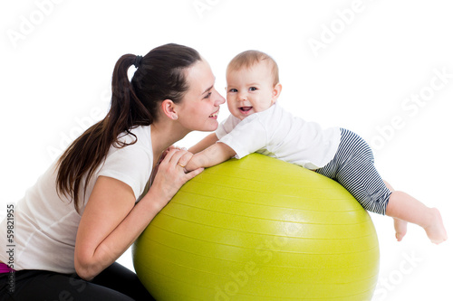 Photo: mother and baby having fun with gymnastic ball mother and baby having fun with gymnastic ball