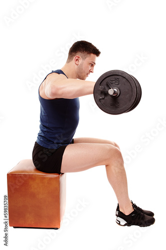 Photo: Handsome man working with heavy dumbbells Handsome man working with heavy dumbbells