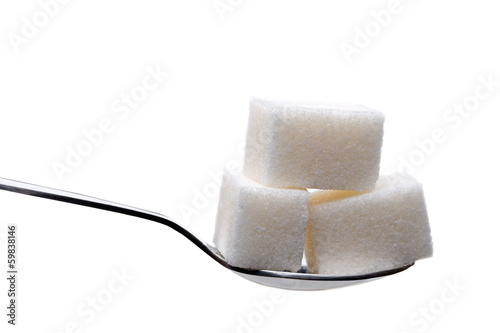 Photo: Spoon with sugar cubes isolated Spoon with sugar cubes isolated