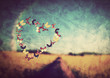 Heart shape made of butterflies on vintage field background Heart shape made of butterflies on vintage field background
