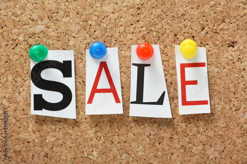 Photo: The word Sale on a cork notice board The word Sale on a cork notice board
