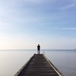 people standing on jetty people standing on jetty