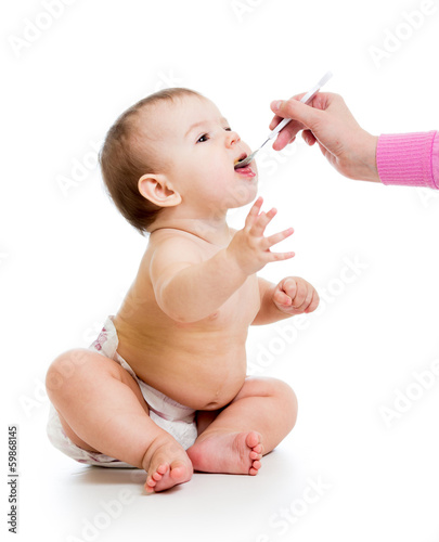 Photo: mother feeding baby with a spoon mother feeding baby with a spoon