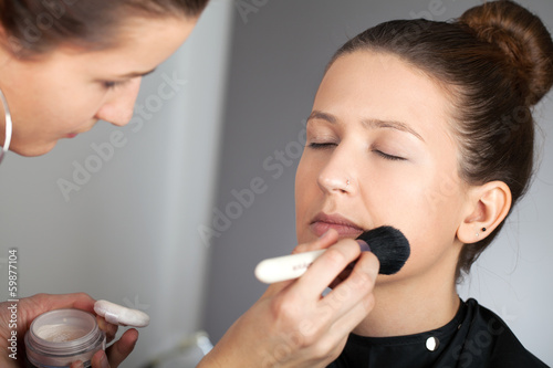 Photo: Make-up artist applying powder Make-up artist applying powder