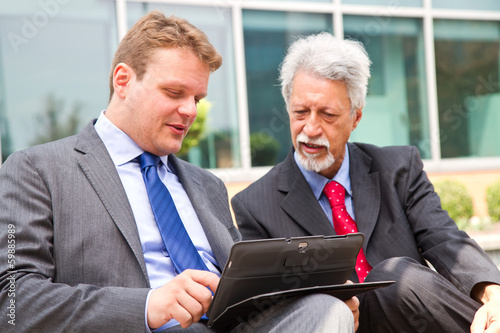 Photo: Two business men partner talking about project Two business men partner talking about project