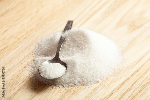 Photo: Spoon in a pile of sugar Spoon in a pile of sugar