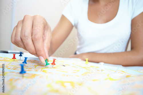 Photo: woman looking at world map woman looking at world map