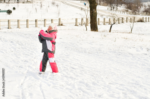 Photo: Cute little brother and sister hugging in the snow Cute little brother and sister hugging in the snow