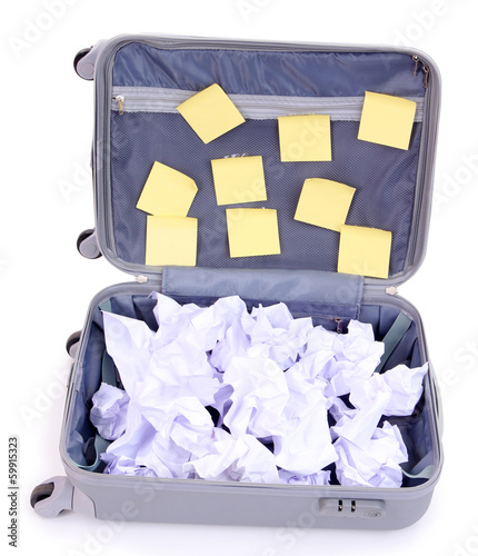 Photo: Open suitcase with paper stickers isolated on white Open suitcase with paper stickers isolated on white