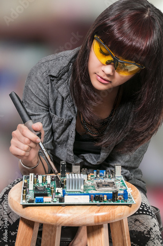 Photo: Woman soldering Woman soldering