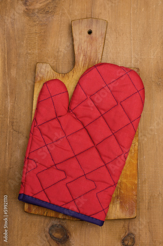 Photo: potholder on a wooden background potholder on a wooden background