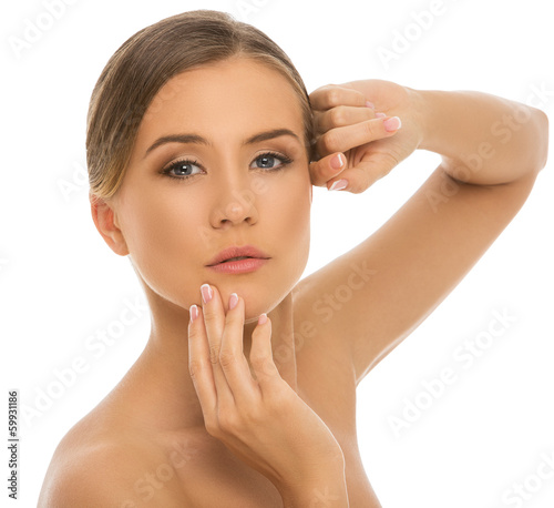 Photo: Beautiful, serious girl with perfect skin on a white background Beautiful, serious girl with perfect skin on a white background