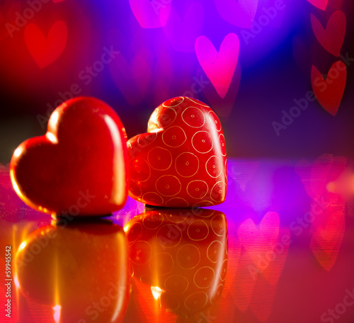 Photo: Couple of Valentines Red Hearts over Abstract Purple Background Couple of Valentines Red Hearts over Abstract Purple Background