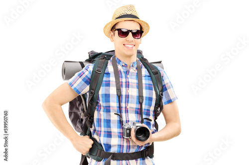 Photo: Male hiker with backpack and camera posing Male hiker with backpack and camera posing