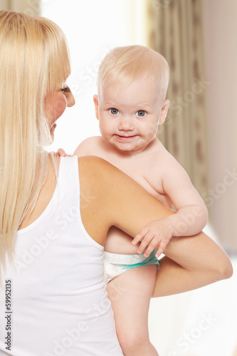 Photo: Happy mother with baby at home Happy mother with baby at home