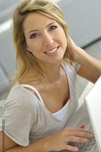 Photo: Attractive woman working on laptop computer Attractive woman working on laptop computer