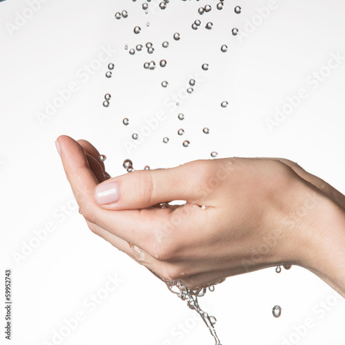 Photo: female hands under the falling drops of water female hands under the falling drops of water