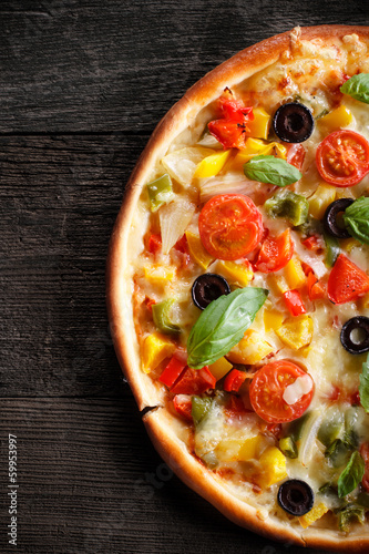 Photo: Pizza on wood texture background Pizza on wood texture background