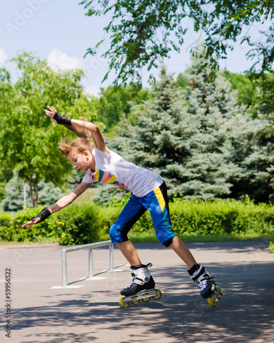 Photo: Teenage girl roller blading in a skate park Teenage girl roller blading in a skate park