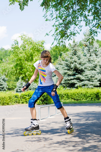 Photo: Young girl practising in a skate park Young girl practising in a skate park
