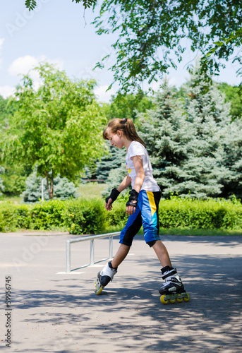 Photo: Young girl practising in a skate park Young girl practising in a skate park