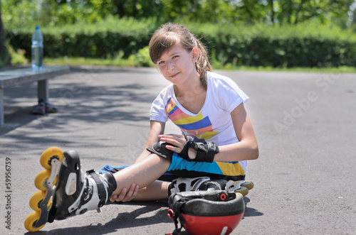 Photo: Roller skater looking at her bruised arm Roller skater looking at her bruised arm