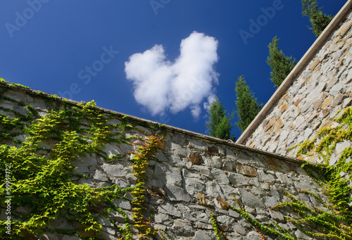 Photo: High stone perimeter wall High stone perimeter wall