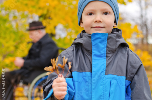 Photo: Small boy and his grandfather outdoors Small boy and his grandfather outdoors