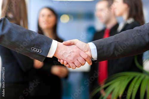 Photo: Image of business partners handshake on signing contract Image of business partners handshake on signing contract