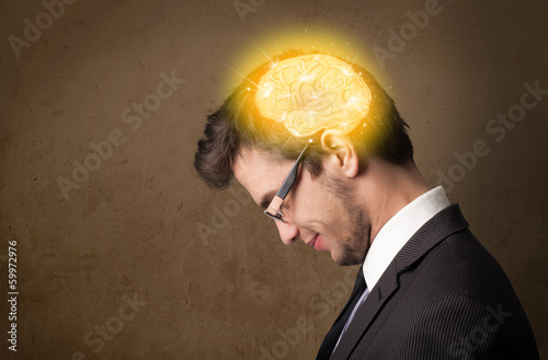 Photo: Young man thinking with glowing brain illustration Young man thinking with glowing brain illustration