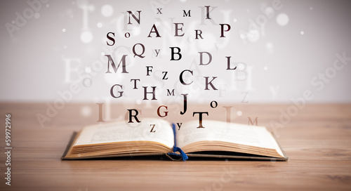 Photo: Opened book with flying letters Opened book with flying letters