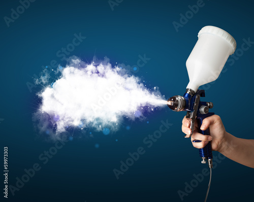 Photo: Painter with airbrush gun and white magical smoke Painter with airbrush gun and white magical smoke