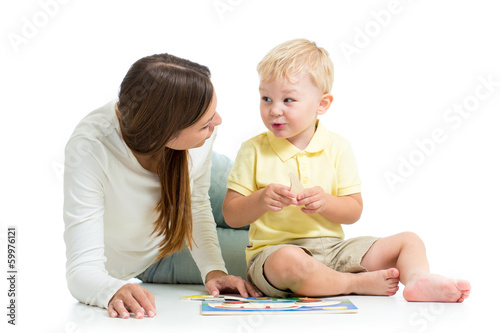 Photo: child boy and mother play together with puzzle toy child boy and mother play together with puzzle toy