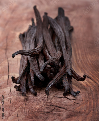 Photo: Vanilla pods on wooden background Vanilla pods on wooden background