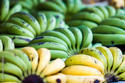 Photo: green and yellow bananas fruits in the market green and yellow bananas fruits in the market
