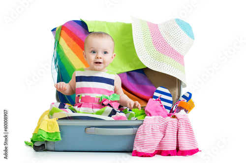 Photo: Kid girl sitting in suitcase Kid girl sitting in suitcase